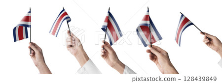 The Costa Rica flag in hand in different angles on a white background 128439849