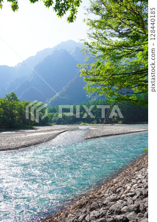Nagano, Kamikochi: The beautiful Azusa River surrounded by fresh greenery in early summer 128440185