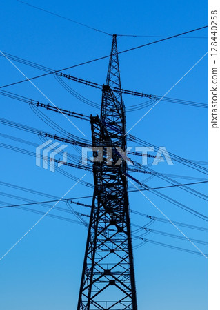 High Voltage Power Lines Against a Clear Sky Industrial Infrastructure and Energy Delivery High Voltage Power Lines Against a Clear Sky Industrial Infrastructure and Energy Delivery 128440258