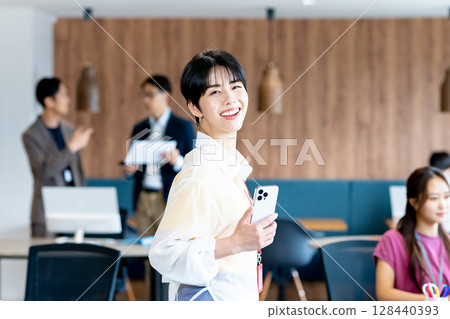 Business woman using a smartphone in the office 128440393