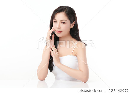 A beautiful young Asian woman with clean, fresh skin against a white background. Skincare, facial treatment, cosmetology, beauty, and spa. An elegant portrait of an Asian woman. 128442072
