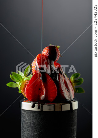 Fresh strawberries and melted dark chocolate. 128442325