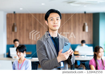 在辦公室使用智能手機的商務人士 在辦公室使用智能手機的商務人士 128442550
