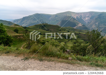 Chokhsky terraces Dagestan. Landscape of mountainous Dagestan with terraced fields and peaks mountains in the distance. 128442668