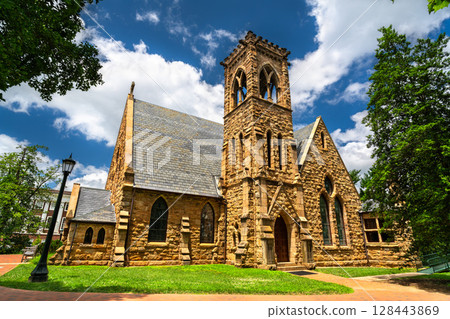 Gothic-style University Chapel on the campus of the University of Virginia in Charlottesville, United States, featuring pointed arches, stained-glass windows and a bell tower surrounded by trees Gothic-style University Chapel on the campus of the University of Virginia in Charlottesville, United States, featuring pointed arches, stained-glass windows and a bell tower surrounded by trees 128443869