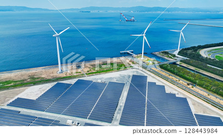 Aerial view of a hybrid power plant with wind turbines and solar panels Aerial view of a hybrid power plant with wind turbines and solar panels 128443984