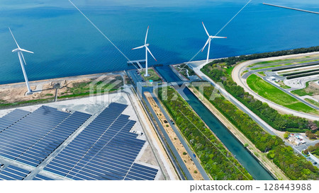 Aerial view of a hybrid power plant with wind turbines and solar panels Aerial view of a hybrid power plant with wind turbines and solar panels 128443988