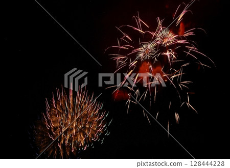 Fireworks exploding in the night sky 128444228