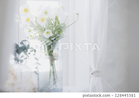 Flowers placed on the window side Flowers placed on the window side 128445381