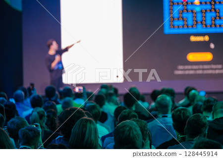 Speaker presenting at a business seminar in a conference hall 128445914