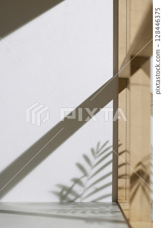 Soft sunlight through wooden windows, shadows, green leaves and texture of white walls. Soft sunlight through wooden windows, shadows, green leaves and texture of white walls. 128446375