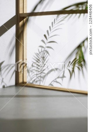 Soft sunlight through wooden windows, shadows, green leaves and texture of white walls. Soft sunlight through wooden windows, shadows, green leaves and texture of white walls. 128446406