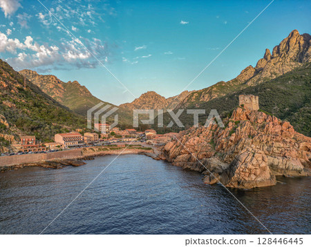 Aerial view town ruins Genoese tower of Porto Corsica France medieval watchtower Mediterranean Sea Calanches de Piana 128446445