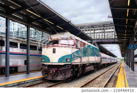 Passenger train from Portland at King Street Station in Seattle, Washington, United States, positioned under a covered platform with modern glass and metal structures 128446458