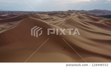 Aerial view of sand dunes in desert at sunset Aerial view of sand dunes in desert at sunset 128446552