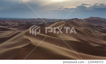 Aerial view of sand dunes in desert at sunset 128446553