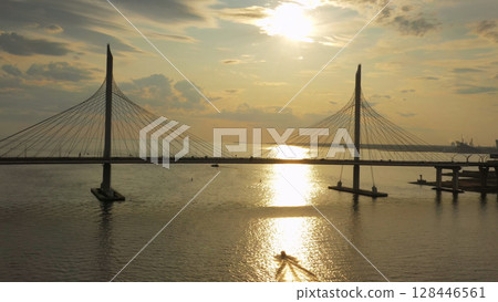 Cable-stayed bridge and new skyscraper at sunset Cable-stayed bridge and new skyscraper at sunset 128446561