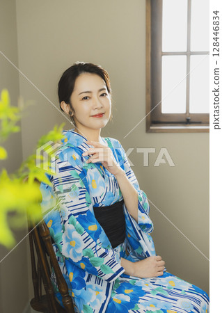 A woman in a yukata by the window A woman in a yukata by the window 128446834