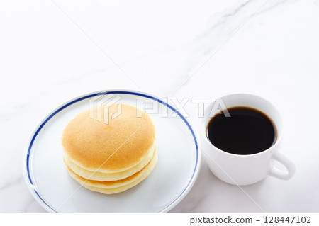 Enjoy a coffee break with fluffy, delicious pancakes and freshly brewed coffee. Enjoy a coffee break with fluffy, delicious pancakes and freshly brewed coffee. 128447102