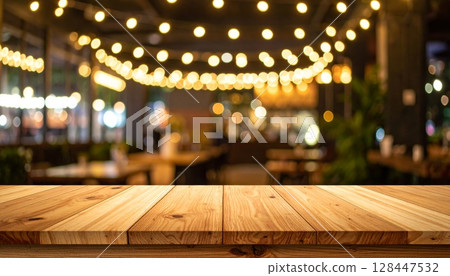 Christmas lights glow on a wooden background, creating a festive holiday bokeh Christmas lights glow on a wooden background, creating a festive holiday bokeh 128447532