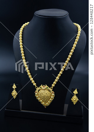 Traditional Indian Gold Necklace Set on Black Display 128448217