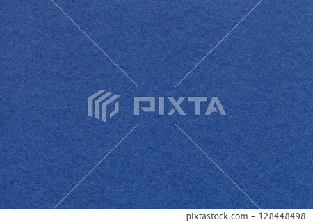 Texture of navy blue paper background with macro structure. Vintage dark denim cardboard backdrop closeup 128448498