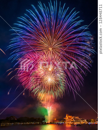 Large fireworks blooming in the night sky 128448711
