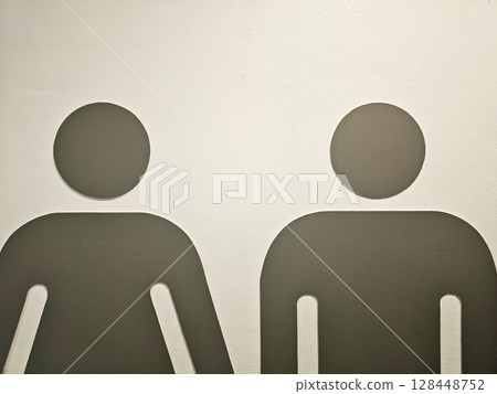 Close up Male and Female Figures on White Wall for Restroom Sign. Close up Male and Female Figures on White Wall for Restroom Sign. 128448752