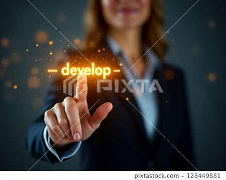 Hand reaching towards glowing word develop during a professional event or workshop focused on growth and innovation 128449881