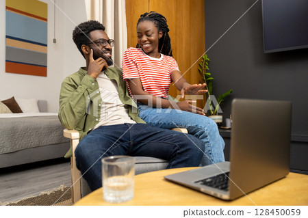 Young couple spending time together and looking contented Young couple spending time together and looking contented 128450059