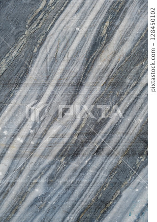This beautiful gray and white marble features stunning, flowing patterns that enhance its natural veining and texture for creative designs. 128450102