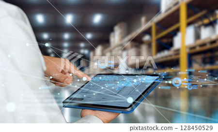 Engineers and digital networks using tablets at a distribution warehouse 128450529