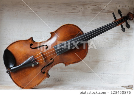 violin - an orchestral or solo professional bowed musical instrument with four strings. loved by children and adults. used in classical folk popular and jazz music violin - an orchestral or solo professional bowed musical instrument with four strings. loved by children and adults. used in classical folk popular and jazz music 128450876