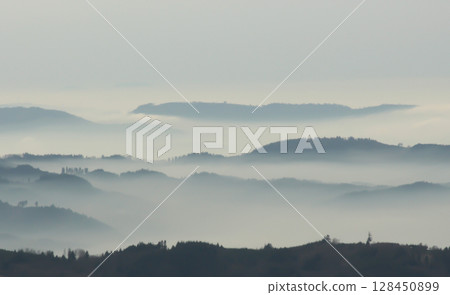 a mysterious landscape of mountains shrouded in fog and towering over the Mummelsee in Germany a mysterious landscape of mountains shrouded in fog and towering over the Mummelsee in Germany 128450899