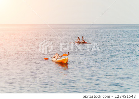Fishermen Boats Sea - Two fishermen in a small boat on the open ocean with a boat in the distance. Fishermen Boats Sea - Two fishermen in a small boat on the open ocean with a boat in the distance. 128451548