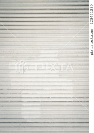 Light gray metal roller door with horizontal lines. Old window. Light gray metal roller door with horizontal lines. Old window. 128451859
