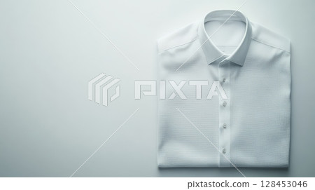 Folded white dress shirt on plain background for business attire 128453046