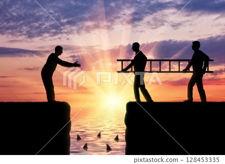 Silhouette two men carry a ladder to pave the way across the abyss for another man 128453335