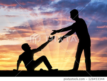 Silhouette of a man giving a helping hand to another man who fell to the ground 128453344