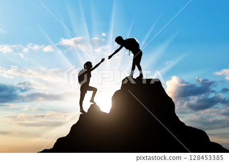 Silhouettes two women climber on top of the mountain. Silhouettes two women climber on top of the mountain. 128453385