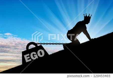 The silhouette of an egotistic man with a crown on his head creeps up. To his feet is bound the load - the ego 128453403
