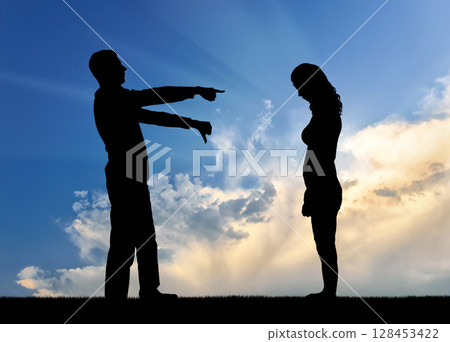 A silhouette of a man showing a finger at a woman telling her that she is a loser 128453422