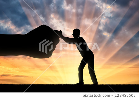 Silhouette of man resists big fist hand Silhouette of man resists big fist hand 128453505