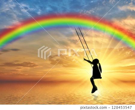 Silhouette, little girl child on a swing rainbow over the sea. Silhouette, little girl child on a swing rainbow over the sea. 128453547