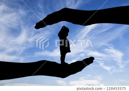 Little sad girl the child cries standing in big hands 128453575