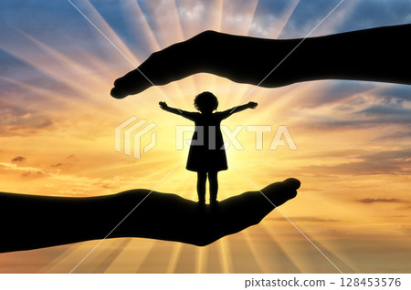 A happy baby girl in big hands, protect her 128453576
