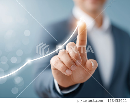 The hand of a man in a suit manipulating a digital graph 128453621