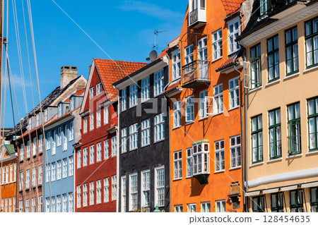The famous Nyhavn area in the historical part of the city of Copenhagen with traditional houses and boats 128454635