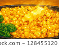 A delicious dish of corn and butter slowly grilled on an iron plate 128455120