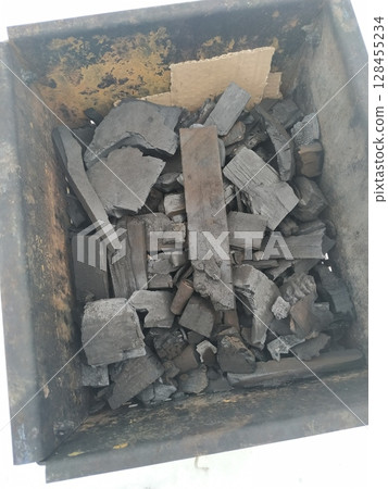 Red Hot Charcoal Coals burning bright orange inside Grill at Night 128455234